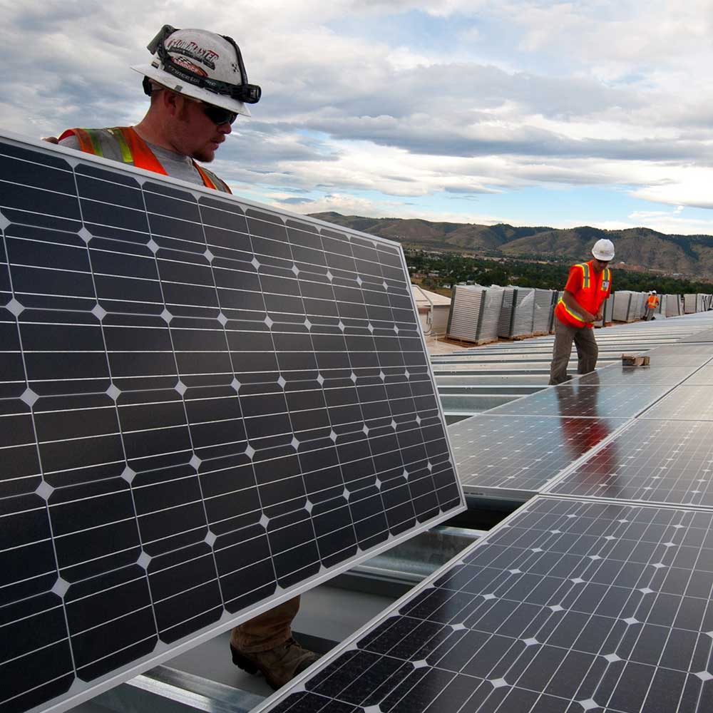 Sunward Grid Solar crew reviewing rooftop plans on site