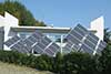 Residential rooftop solar array framed by desert landscaping